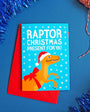 Christmas card with raptor illustration on a blue background