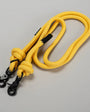 Yellow rope with black clasp on a gray background