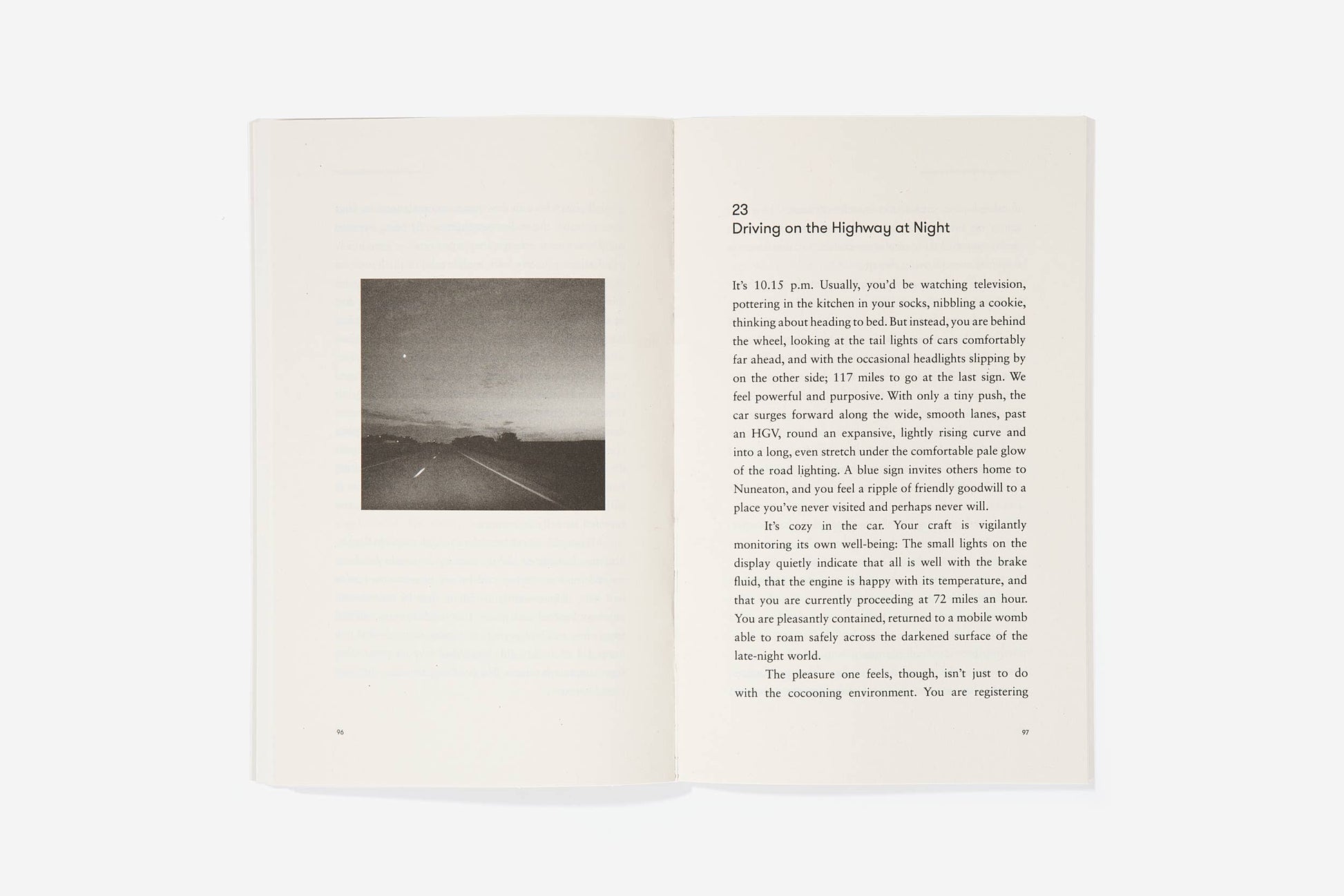 Open book with a black and white photograph of a road at night and text on a white background
