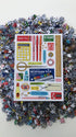 Pile of puzzle pieces with a packaging sheet featuring various tools and items on a white background