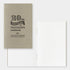 Beige notebook with '20th Anniversary of Traveler's notebook' text on a white background