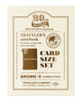 Traveler's notebook card size set packaging with brown leather cover on a beige background