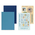 Traveler's Company 2021 guide notebook and sticker set on a white background, featuring a light blue guidebook, a navy blue sheet, a teal blue sheet, and a beige sticker sheet with travel-themed stickers.