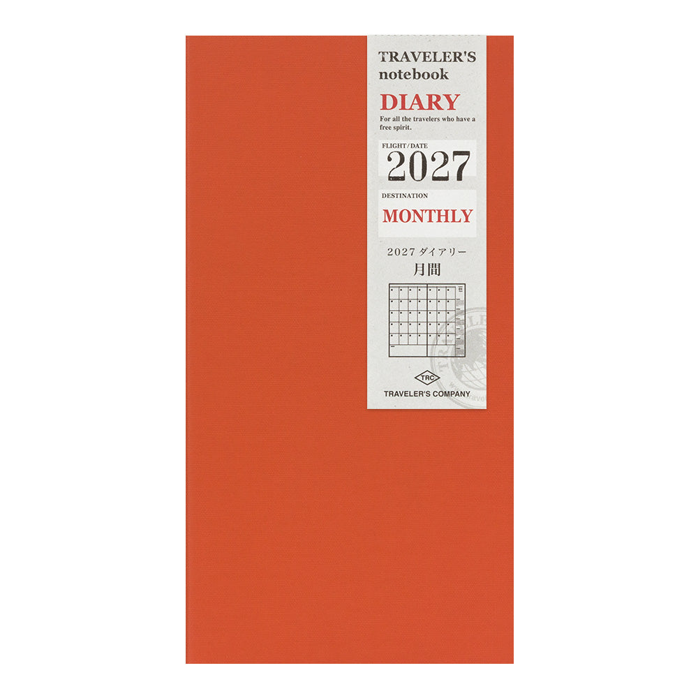A vertical orange-red notebook cover with a white label on the right side. The label reads 'Traveler's notebook DIARY', '2027', 'MONTHLY', and 'Traveler's Company'.