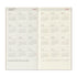 A 2027 to 2028 travelers' notebook calendar spread showing a monthly layout in beige and cream tones with the text 'TRAVELER'S notebook' and 'For all the travelers who have a free spirit.'.