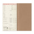 A traveler's departure card notebook shown open, featuring a tan kraft-paper cover and a cream-colored departure card insert with printed fields and text.