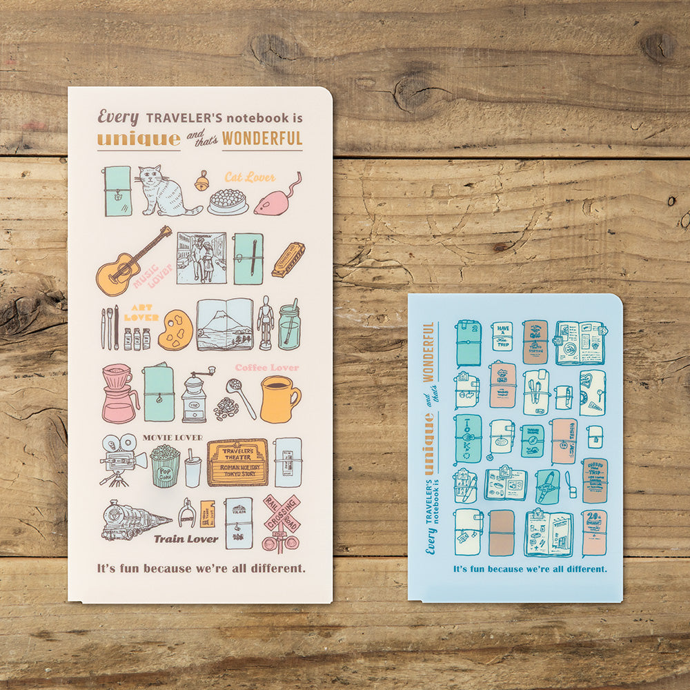 Two decorative notebook covers or sticker sheets displayed on a rustic wooden surface. The left sheet is cream with multicolor travel-themed illustrations and text, and the right sheet is light blue with matching illustrations.