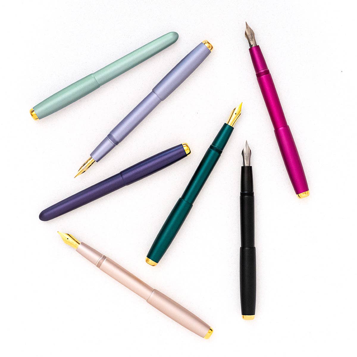 Set of colorful fountain pens on a white background
