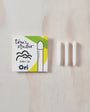 Toni's Studio Ori bullet tip packaging with three white cylindrical items on a wooden surface