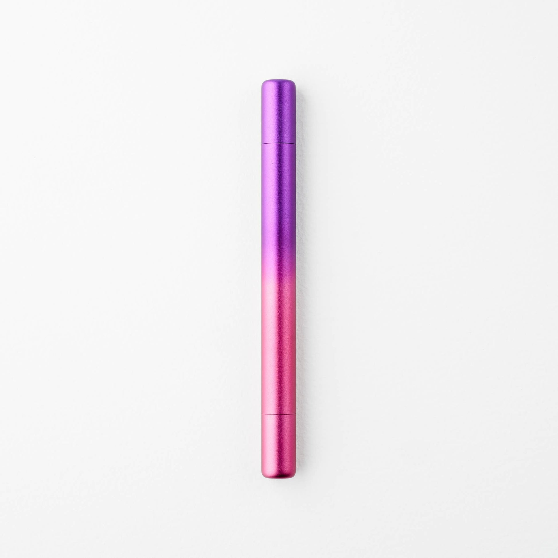 Gradient purple to pink pen on a white background