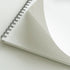 Open notebook with grid paper on a white background