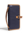 Navy blue and brown bag with strap on a white background