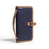 Navy blue and brown bag with strap on a white background
