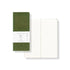 Green notebook with a ruled lines on the cover and ruled  pages open on a white background