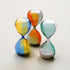 Three colorful hourglass-shaped objects on a light background