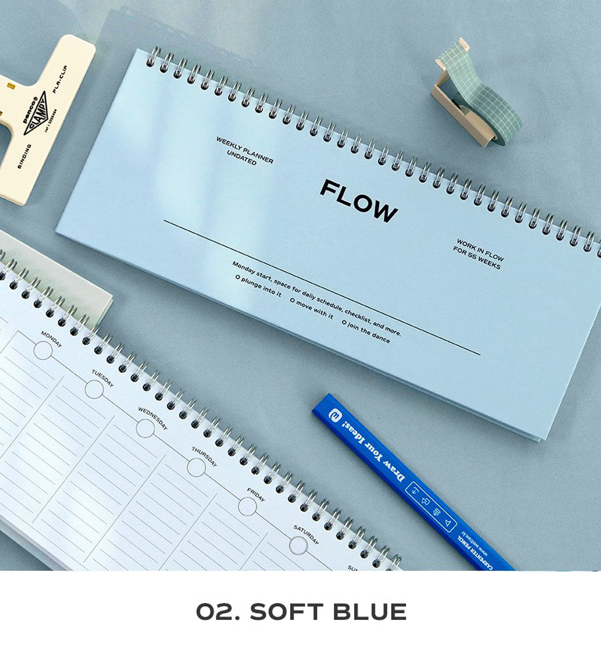 A spiral-bound planner pad in soft blue labeled 'FLOW' is shown on a light blue surface with other stationery items around it, including a white lined notepad, a blue pen, and washi tape. Text at the bottom reads 'O.