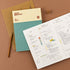 Planner with a pen on a brown background