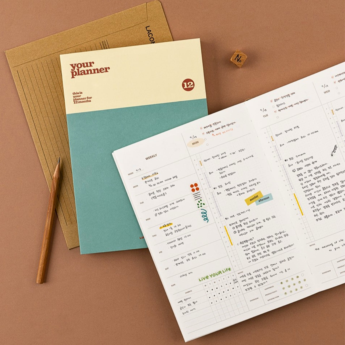 Planner with a pen on a brown background