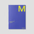 Blue planner with yellow 'M' on a gray background