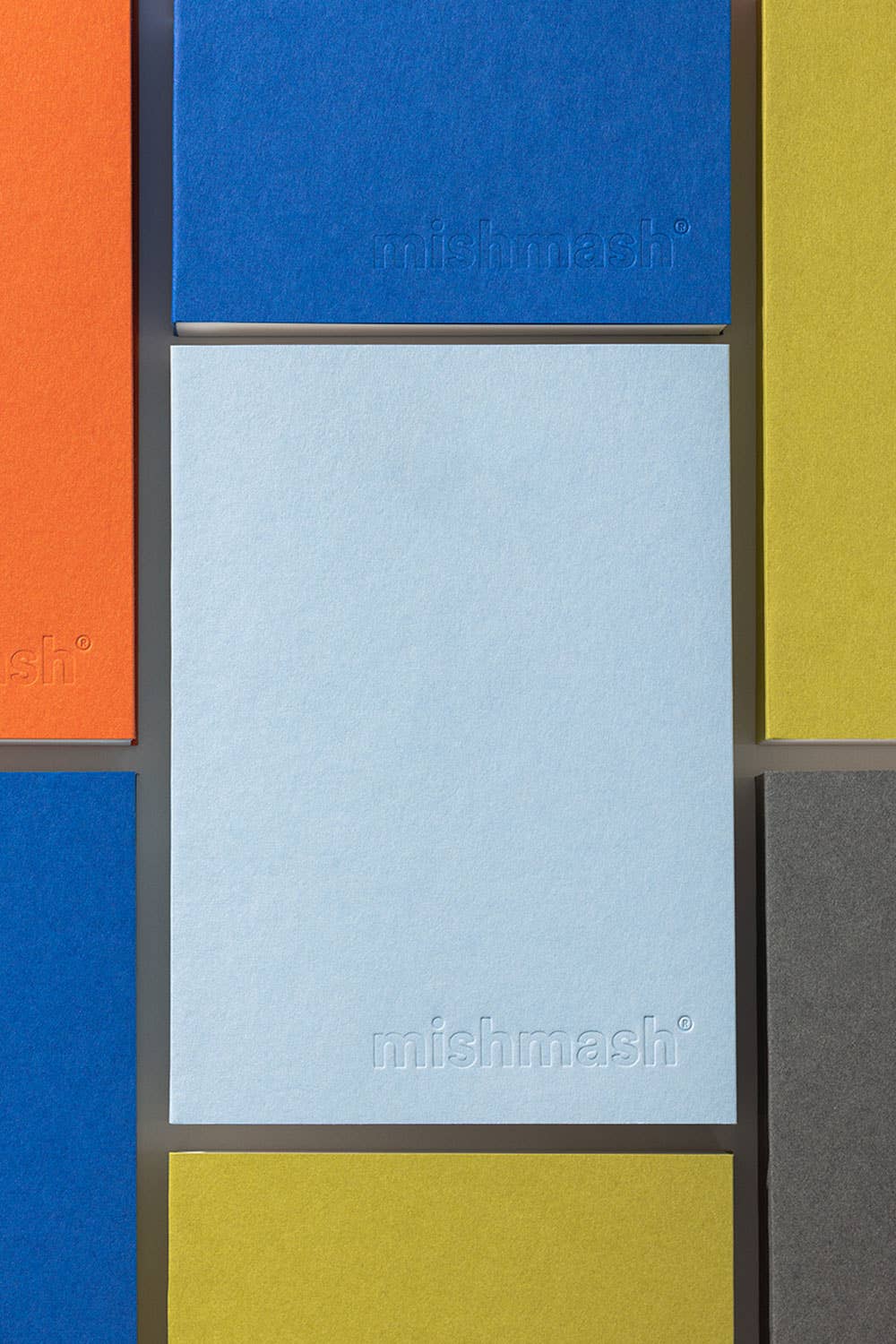 Colorful geometric pattern with 'mishmash' branding on a textured surface.