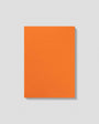 Orange notebook with 'mismast' branding on a light gray background