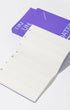 White notepad with purple border and text on a white background