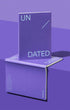 Purple notebook with 'UN' and 'DATED' text on a reflective purple surface