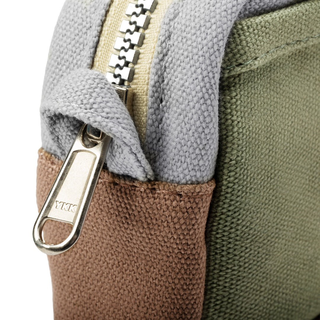 Close-up of a multicolored bag with zipper and keychain attachment.