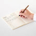 MD paper notebook A5 man writing with pen