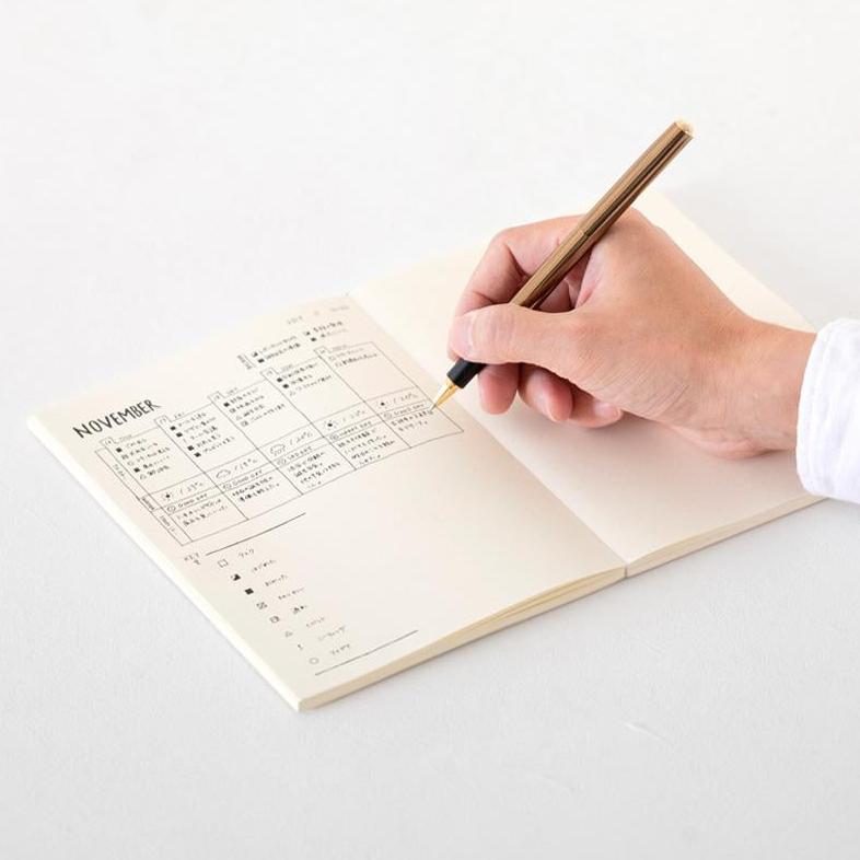 MD paper notebook A5 man writing with pen